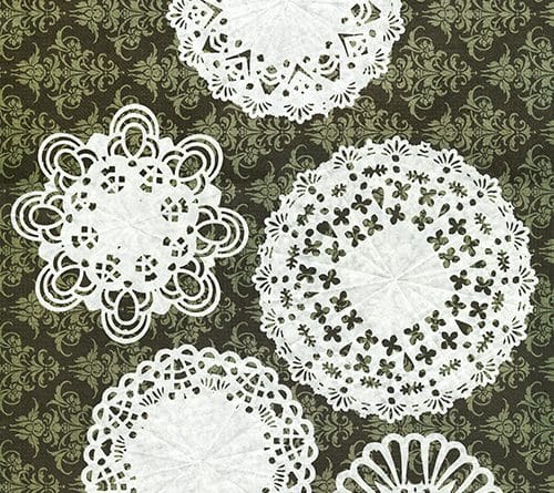 Five white lace paper doilies on a dark patterned background