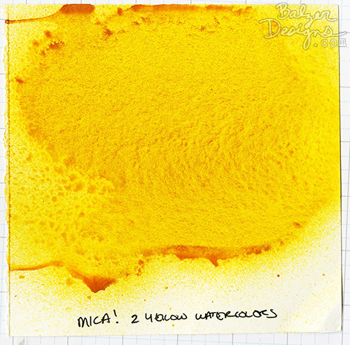 A sample card of yellow spray ink made from watercolor and mica powder.