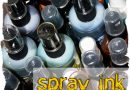 A photo of many bottles of spray ink with the caption "spray ink" written over the bottles.
