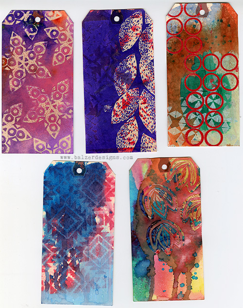 Five mixed media tags that are very colorful.