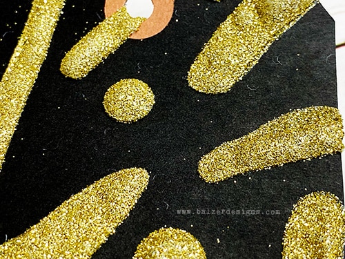 A detail photo of the heat embossing showing the gold sparkle.